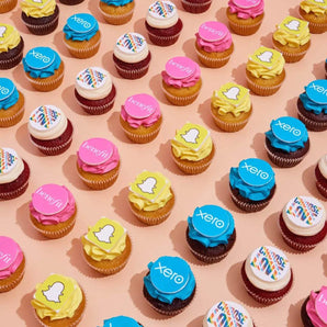 Corporate Cupcakes with Logos featuring vibrant edible logo toppers in various flavors, perfect for corporate events by Crumbs & Doilies